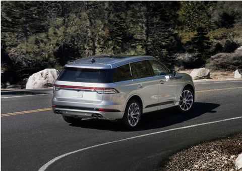A Lincoln Aviator® is being driven on a winding road | John Vance Auto Group in Guthrie OK