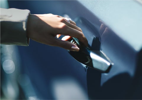 A hand gracefully grips the Light Touch Handle of a 2023 Lincoln Aviator® SUV to demonstrate its ease of use | John Vance Auto Group in Guthrie OK