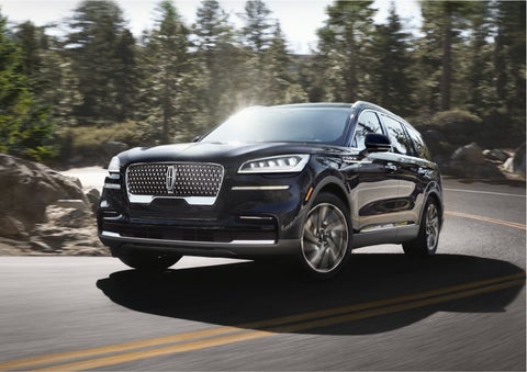 A Lincoln Aviator® SUV is being driven on a winding mountain road | John Vance Auto Group in Guthrie OK